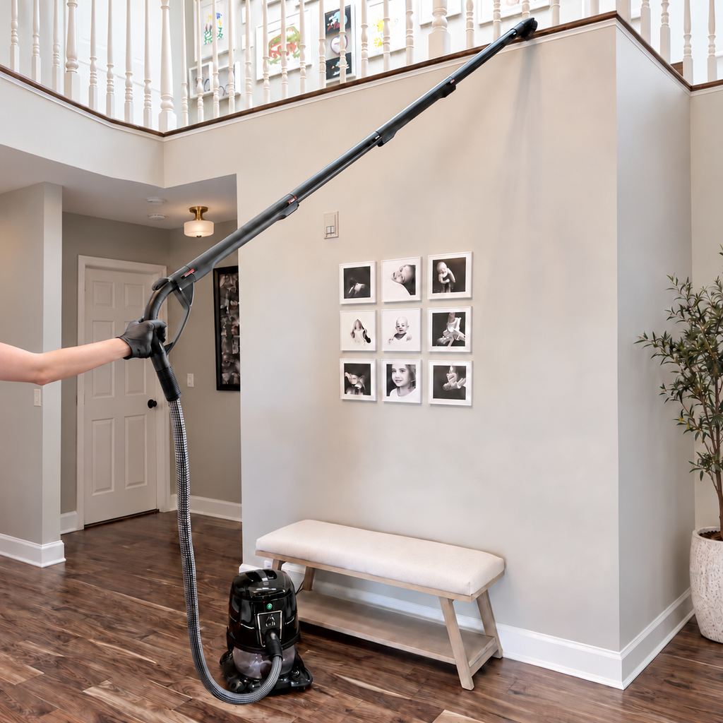 HYLA cleaning system with a hose, four connected tubes and a brush reaching an elevated ledge.